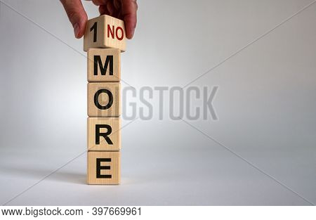 1 Or No More Symbol. Hand Turns A Cube And Changes The Words '1 More' To 'no More'. Beautiful White 