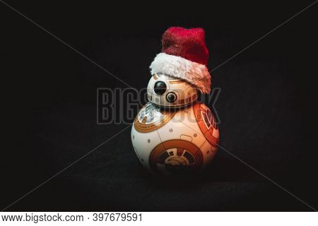 Caba, Argentina, November 28, 2020: Lovely Droid Bb-8 From Star Wars, Wearing A Christmas Hat In Dar