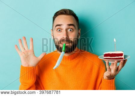 Close-up Of Funny Adult Man Celebrating His Birthday, Holding Bday Cake With Candle, Blowing Party W