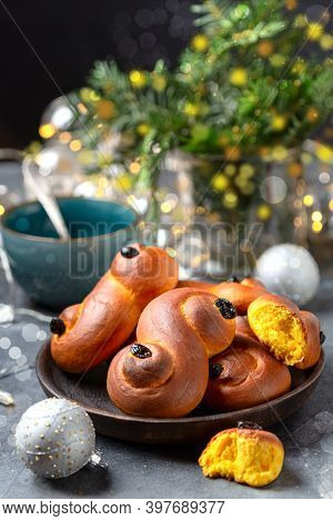 Traditional Swedish Buns In Christmas Setting. Saffron Bun, In Swedish Lussebulle Or Lussekatt. Wint