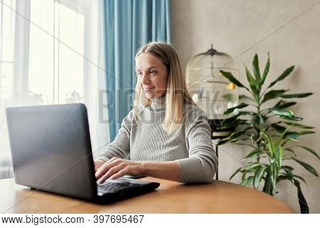 Adoult Woman 35s Working On Laptop At Home, Work From Home, Stay Safe During Coronavirus Covid-2019 
