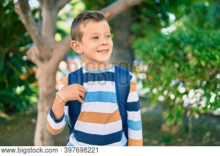 dorable caucasian student boy smiling happy standing at the park.