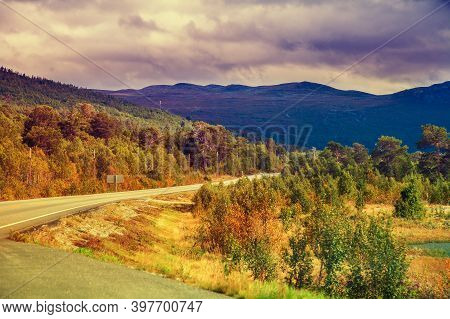 Mountain Road At Sunset With Dramatic Cloudy Sky. Beautiful Nature Norway. Colorful Autumn. Mountain