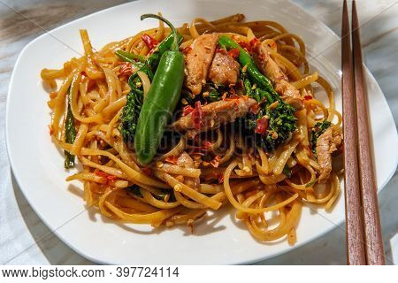 Pad Kee Mao Otherwise Known As Drunken Noodles Is A Spicy Thai Stir-fried Noodle Dish With Thinly Sl