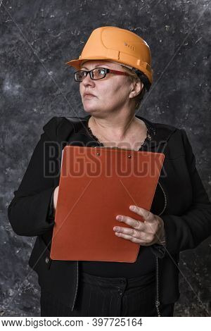 Middle-aged Woman Construction Superintendent In Helmet Studio Portrait.