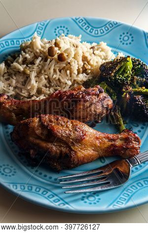 Authentic Spicy Jamaican Jerk Chicken Legs Served With Coconut Rice And Pigeon Peas
