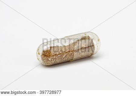 Transparent Pill, Only Partialy Filled With Brown Ingredient
