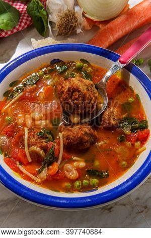 Loaded Italian Tomato Meatball Soup With Cannellini Beans Spinach Green Peas And Parmesean Rind