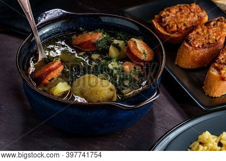 Traditional Portuguese Caldo Verde Chourico Soup With Orzo Rice Pilaf And Petiscos