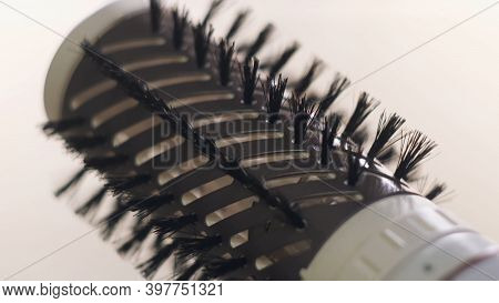 Close Up Of Hot Air Rotating Hair Styler In Female Hands. Concept. Woman Hands Showing The Work Of A