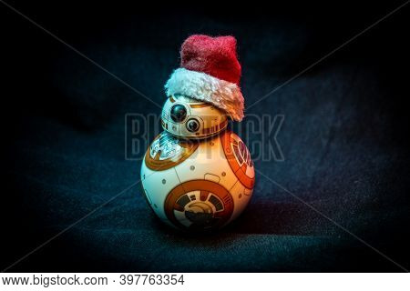 Caba, Argentina, November 28, 2020: Lovely Droid Bb-8 From Star Wars, Wearing A Christmas Hat In Dar