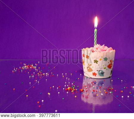 One Birthday Cup Cake And Candle On The Purple Background And Reflect On The Floor With Colorful Rou