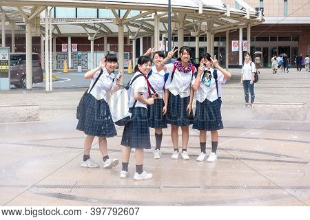 Oita, Kyushu, Japan August 04,2017: Young Japanese Schoolgirls Have Fun On The Way From School On Th