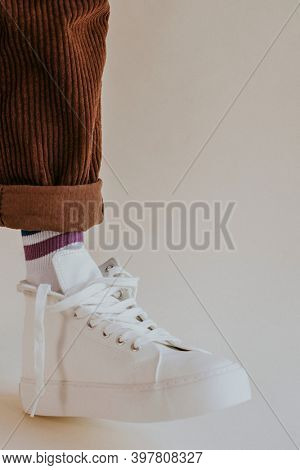 Man leg in sneakers with untied laces