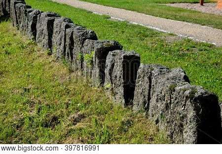 Separation Of The Park From The Road By A Series Of Granite Columns Of Menhirs Or Bollards Which Sta