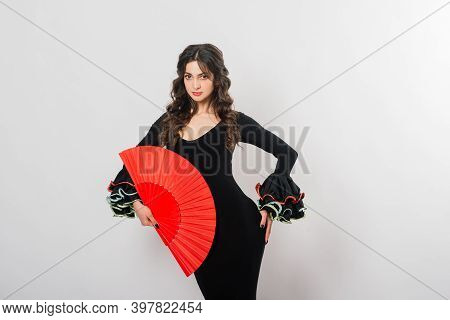 Portrait Of Beautiful Young Woman Dancing Flamenco In Studio