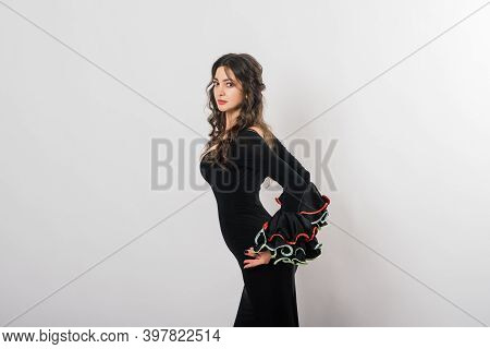 Portrait Of Beautiful Young Woman Dancing Flamenco In Studio