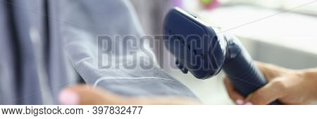 In Hand Of A Steam Steamer For Clothes Which Iron Sleeve. Steamers In Daily Use Concept