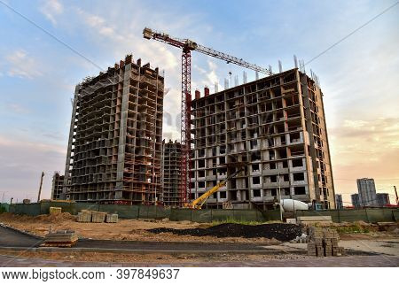 Preparing To Pour A Bucket Of Concrete Into Formwork.tower Crane Lifting Cement Bucket During Constr