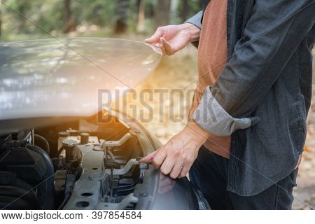 Close Up Hand Man Open Car Hood For Repair As Maintenance Service. Man Trying To Repair A Car Engine