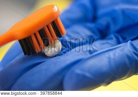 Tooth brush and deciduous milk child teeth on yellow background