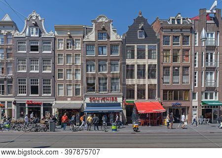 Amsterdam, Netherlands - May 14, 2018: Traditional Hosues With Shops At Street In Amsterdam, Holland