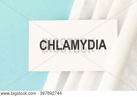 Word Chlamydia With Medical Mask On A Blue Background.