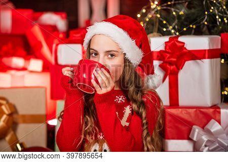 Kid In Santa Hat With Many Gift Boxes. Successful Shopping On Xmas Market. Decorated With Gifts. Sho