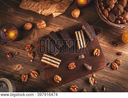 Gerbeaud Bars Filled With Plum Marmalade And Crushed Walnuts, Topped With Chocolate Glaze On Wooden 