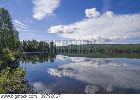 Clouds Reflecting In Lake Funasdalssjon Close To The Swedish Village Funasdalen