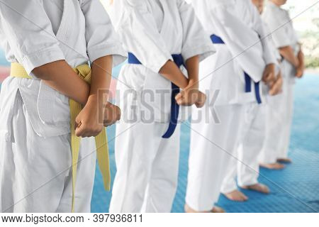 Children In Kimono During Karate Practice On Tatami, Closeup