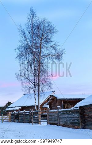 Irkutsk, Russia- 8 January 2019: Winter Landscape With Wooden Houses Trees And Colorful Sky Museum T
