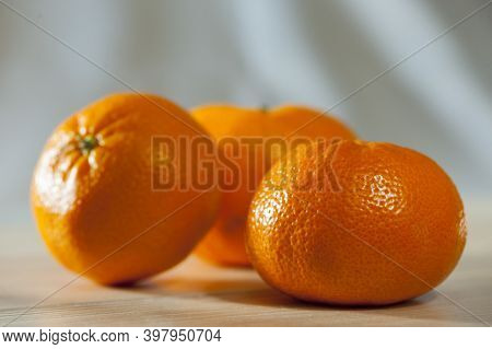 Delicious Tangerines. Juicy Bright Orange Tsytrus On A White Background. Tangerines On A White Woode