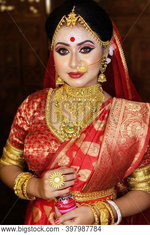 Portrait Of Very Beautiful Indian Bride Holding Traditional Wooden Sindur Or Sindoor Box In Hand, We