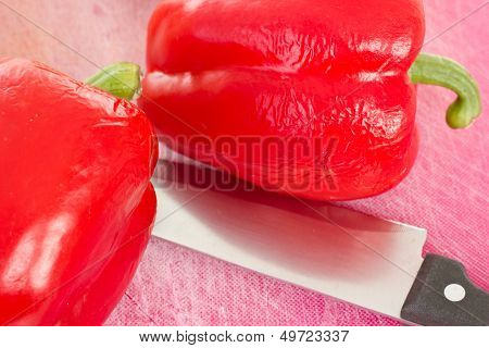 Two Red Peppers Waiting To Be Cutted