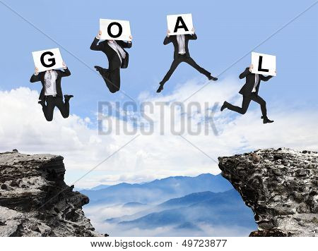 Businessman Jumping With Goal Text On Danger Precipice