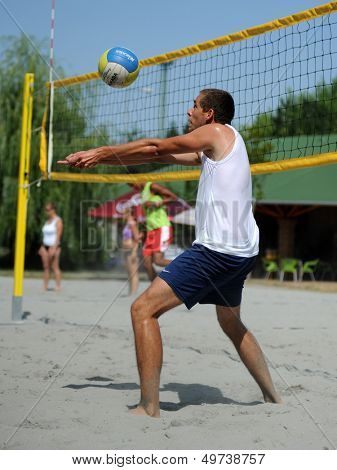 KAPOSVAR, HUNGARY - AUGUST 4: Tamas Vajda in action at a ROAK Viragfurdo Kupa beach volleyball competition, August 4, 2013 in Kaposvar, Hungary.