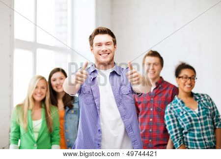 education - student ith group of students at school showing thumbs up