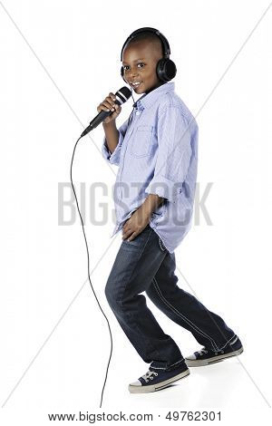 Full-length image of a happy elementary DJ leaning into the mike.  On a white background.