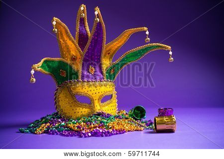 Festive Grouping of mardi gras, venetian or carnivale mask on a purple background