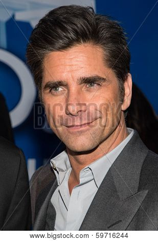 NEW YORK-JAN 29: Actor John Stamos (R) visits the Dannon Oikos Tent on Park Avenue on January 29, 2014 in New York City.