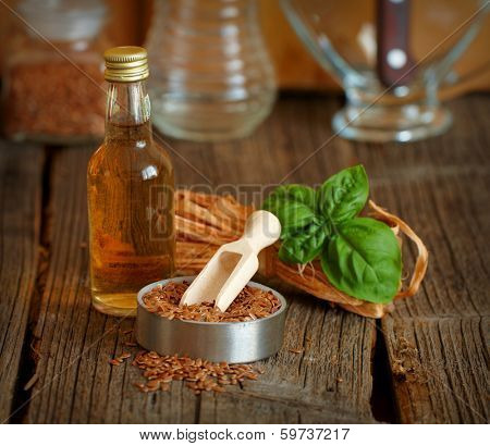 Dried linseed with macerated oil isolated on wooden table