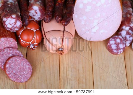 Different sausages on wooden table close-up