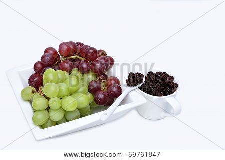 Bunch of red and green grapes and raisins