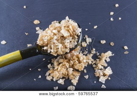 Smoked Sea Salt Flakes, On A Wooden Spoon And Scattered. Macro.