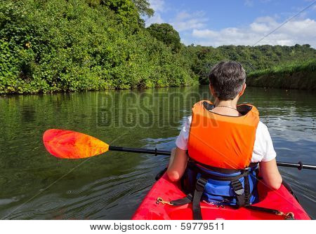 Senior Lady In Canoe Approaching Hanalei Bridge