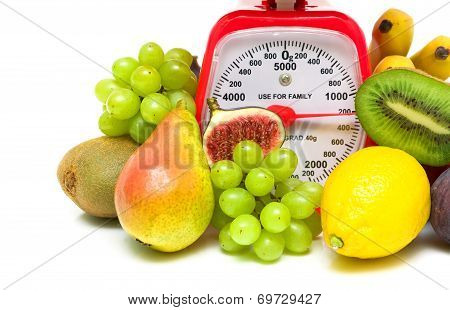 Fruit And Kitchen Scales Close Up On White Background