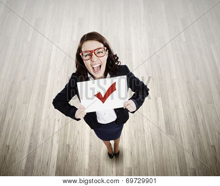Top view of businesswoman holding white banner with red tick