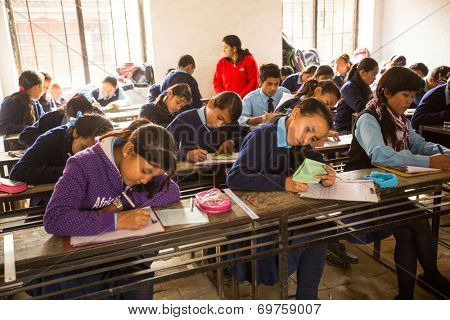 KATHMANDU, NEPAL - DEC 19, 2013 : Unknown children in the lesson at public school. Adult literacy (age 15+) 60.3% (female: 46.3%, male: 73%) in a 2010 population census.