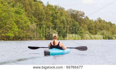 Woman On A Small River In Rural Landscape